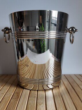 Vintage silver-plated ice bucket features a high-polish finish over brass base
